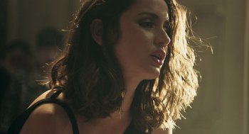 Movie still from “Deep Water” (2022), directed by Adrian Lyne – A person with long brown hair; Close Up shot, Low angle