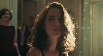 Movie still from “Deep Water” (2022), directed by Adrian Lyne – A beautiful woman with long brown hair looking to her left; Close Up shot, Low angle