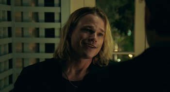 Movie still from “Deep Water” (2022), directed by Adrian Lyne – A person with long blonde hair; Close Up shot, Over the shoulder angle