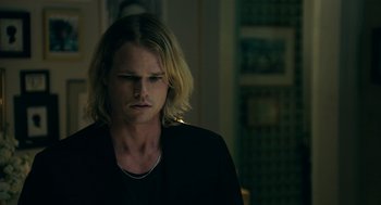 Movie still from “Deep Water” (2022), directed by Adrian Lyne – A person with long blonde hair; Close Up shot, Over the shoulder angle