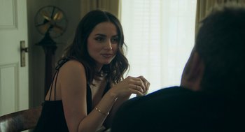 Movie still from “Deep Water” (2022), directed by Adrian Lyne – A woman sitting in front of a man in front of a window; Close Up shot, Over the shoulder angle