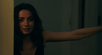 Movie still from “Deep Water” (2022), directed by Adrian Lyne – A woman with long dark curly hair is pointing at the camera; Close Up shot, Over the shoulder angle