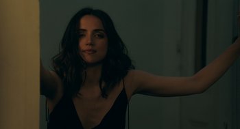 Movie still from “Deep Water” (2022), directed by Adrian Lyne – A beautiful young woman in a black dress; Close Up shot, Over the shoulder angle
