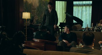 Movie still from “Deep Water” (2022), directed by Adrian Lyne – Two men sitting in a living room next to each other; Wide shot, Over the shoulder angle