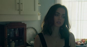 Movie still from “Deep Water” (2022), directed by Adrian Lyne – A beautiful young woman with shoulder - length dark hair; Close Up shot, Over the shoulder angle