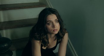 Movie still from “Deep Water” (2022), directed by Adrian Lyne – A beautiful young lady sitting on top of steps; Close Up shot, High angle