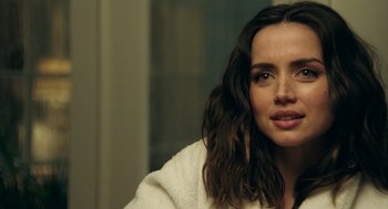 Movie still from “Deep Water” (2022), directed by Adrian Lyne – A person sitting in front of a window; Close Up shot, Over the shoulder angle