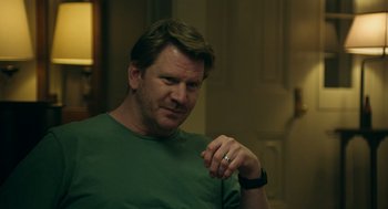 Movie still from “Deep Water” (2022), directed by Adrian Lyne – A person wearing a green t - shirt; Close Up shot, Over the shoulder angle