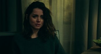 Movie still from “Deep Water” (2022), directed by Adrian Lyne – A woman sitting in front of a window; Close Up shot, Over the shoulder angle