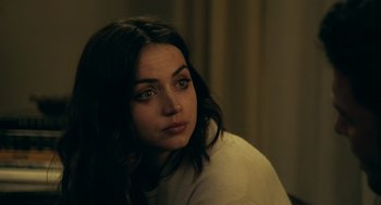 Movie still from “Deep Water” (2022), directed by Adrian Lyne – A person sitting in front of a curtain; Close Up shot, Over the shoulder angle