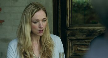 Movie still from “Deep Water” (2022), directed by Adrian Lyne – A beautiful blonde haired woman holding a wine glass; Close Up shot, Over the shoulder angle