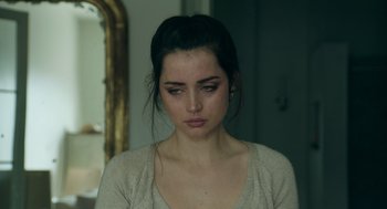 Movie still from “Deep Water” (2022), directed by Adrian Lyne – A young woman is looking down at the floor; Close Up shot, Over the shoulder angle
