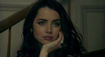 Movie still from “Deep Water” (2022), directed by Adrian Lyne – A beautiful woman with long black hair wearing a ring; Close Up shot, Over the shoulder angle