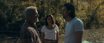 A man and a woman talk to a man in a white shirt