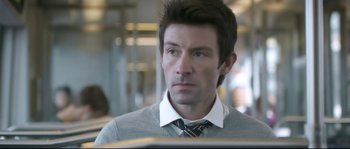 Movie still from “Upstream Color” (2013), directed by Shane Carruth – A person wearing a shirt and a tie; Close Up shot, Over the shoulder angle