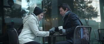 Movie still from “Upstream Color” (2013), directed by Shane Carruth – A man and a woman are sitting at an outdoor table with coffee; Medium shot, High angle
