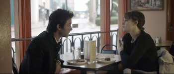 Movie still from “Upstream Color” (2013), directed by Shane Carruth – A man and a woman sitting at a restaurant table; Medium shot, Over the shoulder angle