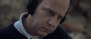 Movie still from “Upstream Color” (2013), directed by Shane Carruth – A person wearing headphones; Close Up shot, Low angle