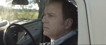 Movie still from “Upstream Color” (2013), directed by Shane Carruth – A person sitting in a car; Close Up shot, Over the shoulder angle