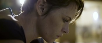 Movie still from “Upstream Color” (2013), directed by Shane Carruth – A woman's face as she looks down; Close Up shot, Low angle