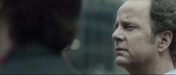 Movie still from “Upstream Color” (2013), directed by Shane Carruth – A man with a bald head is looking into the distance; Close Up shot, Low angle
