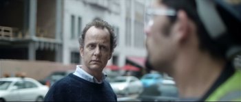 Movie still from “Upstream Color” (2013), directed by Shane Carruth – A person in a street with cars in the background; Close Up shot, Over the shoulder angle