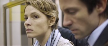 Movie still from “Upstream Color” (2013), directed by Shane Carruth – A person sitting next to another person; Close Up shot, Over the shoulder angle