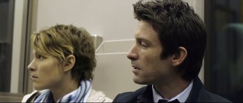 Movie still from “Upstream Color” (2013), directed by Shane Carruth – A man and a woman in a suit and tie looking at each other; Close Up shot, Over the shoulder angle