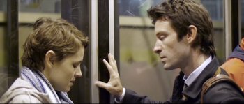 Movie still from “Upstream Color” (2013), directed by Shane Carruth – Two men in business suits on a subway train; Close Up shot, Over the shoulder angle