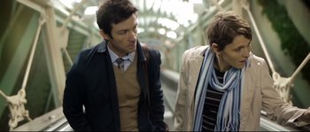 Movie still from “Upstream Color” (2013), directed by Shane Carruth – A man and a woman walking down a train platform; Medium shot, Over the shoulder angle