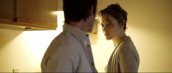 Movie still from “Upstream Color” (2013), directed by Shane Carruth – A man and a woman standing next to each other in front of a window; Close Up shot, Over the shoulder angle