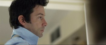 Movie still from “Upstream Color” (2013), directed by Shane Carruth – A person wearing a blue shirt; Close Up shot, Over the shoulder angle