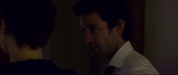 Movie still from “Upstream Color” (2013), directed by Shane Carruth – A person wearing a suit and tie; Close Up shot, Over the shoulder angle