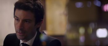 Movie still from “Upstream Color” (2013), directed by Shane Carruth – A person wearing a suit; Close Up shot, Over the shoulder angle