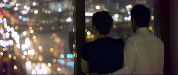 Movie still from “Upstream Color” (2013), directed by Shane Carruth – A woman looking out of a window at night; Medium shot, High angle
