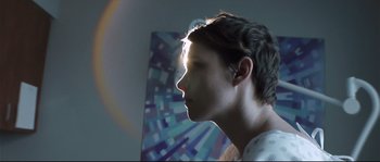 Movie still from “Upstream Color” (2013), directed by Shane Carruth – A young man is looking into the distance; Close Up shot, Low angle