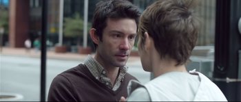 Movie still from “Upstream Color” (2013), directed by Shane Carruth – A man talking to a woman on the sidewalk; Close Up shot, Over the shoulder angle