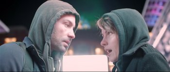 Movie still from “Upstream Color” (2013), directed by Shane Carruth – A man and a woman in hooded jackets face each other; Close Up shot, Low angle