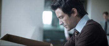 Movie still from “Upstream Color” (2013), directed by Shane Carruth – A person wearing a suit and tie; Close Up shot, Over the shoulder angle