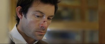 Movie still from “Upstream Color” (2013), directed by Shane Carruth – A person with a bandage on his face; Close Up shot, High angle