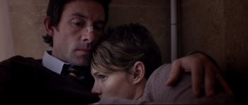 Movie still from “Upstream Color” (2013), directed by Shane Carruth – A man and a woman sitting next to each other on a train; Close Up shot, Overhead angle