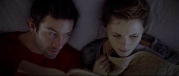Movie still from “Upstream Color” (2013), directed by Shane Carruth – A man and a woman reading a book in bed; Close Up shot, Overhead angle