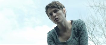 Movie still from “Upstream Color” (2013), directed by Shane Carruth – A person with short hair is looking into the distance; Close Up shot, Low angle