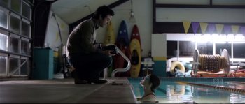 Movie still from “Upstream Color” (2013), directed by Shane Carruth – A man and a woman in a swimming pool; Medium shot, Over the shoulder angle
