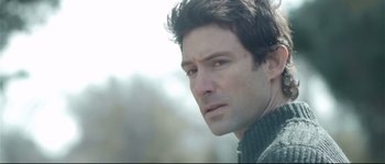Movie still from “Upstream Color” (2013), directed by Shane Carruth – A person wearing a sweater; Close Up shot, Over the shoulder angle