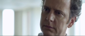 Movie still from “Upstream Color” (2013), directed by Shane Carruth – A man's face with a sad look on his face; Close Up shot, Over the shoulder angle