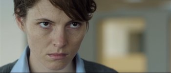 Movie still from “Upstream Color” (2013), directed by Shane Carruth – A woman's face with brown eyes; Close Up shot, Over the shoulder angle