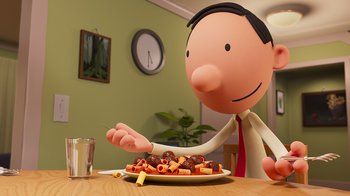 Movie still from “Diary of a Wimpy Kid” (2021), directed by Gino Nichele – A man is sitting at a table with a plate of food on it; Medium shot, Over the shoulder angle