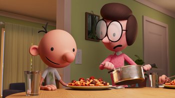 Movie still from “Diary of a Wimpy Kid” (2021), directed by Gino Nichele – A couple of cartoon characters sitting in front of a plate of food; Medium shot, High angle
