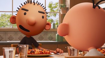 Movie still from “Diary of a Wimpy Kid” (2021), directed by Gino Nichele – Two cartoon characters sitting at a table eating pasta; Close Up shot, Over the shoulder angle